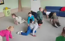 dzieci w ruchu na dywanie w pozycji na czworaka