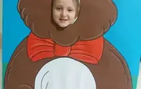dziewczynka z buzią w fotobudce w kształcie brązowego misia