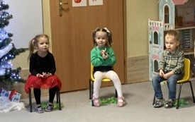 troje dzieci siedzi na krzesełakch